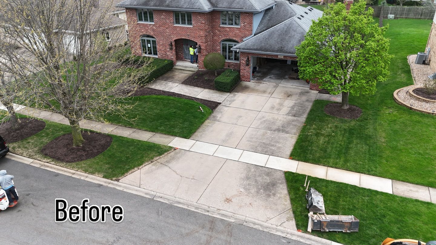 The same home's old, stained driveway before replacement